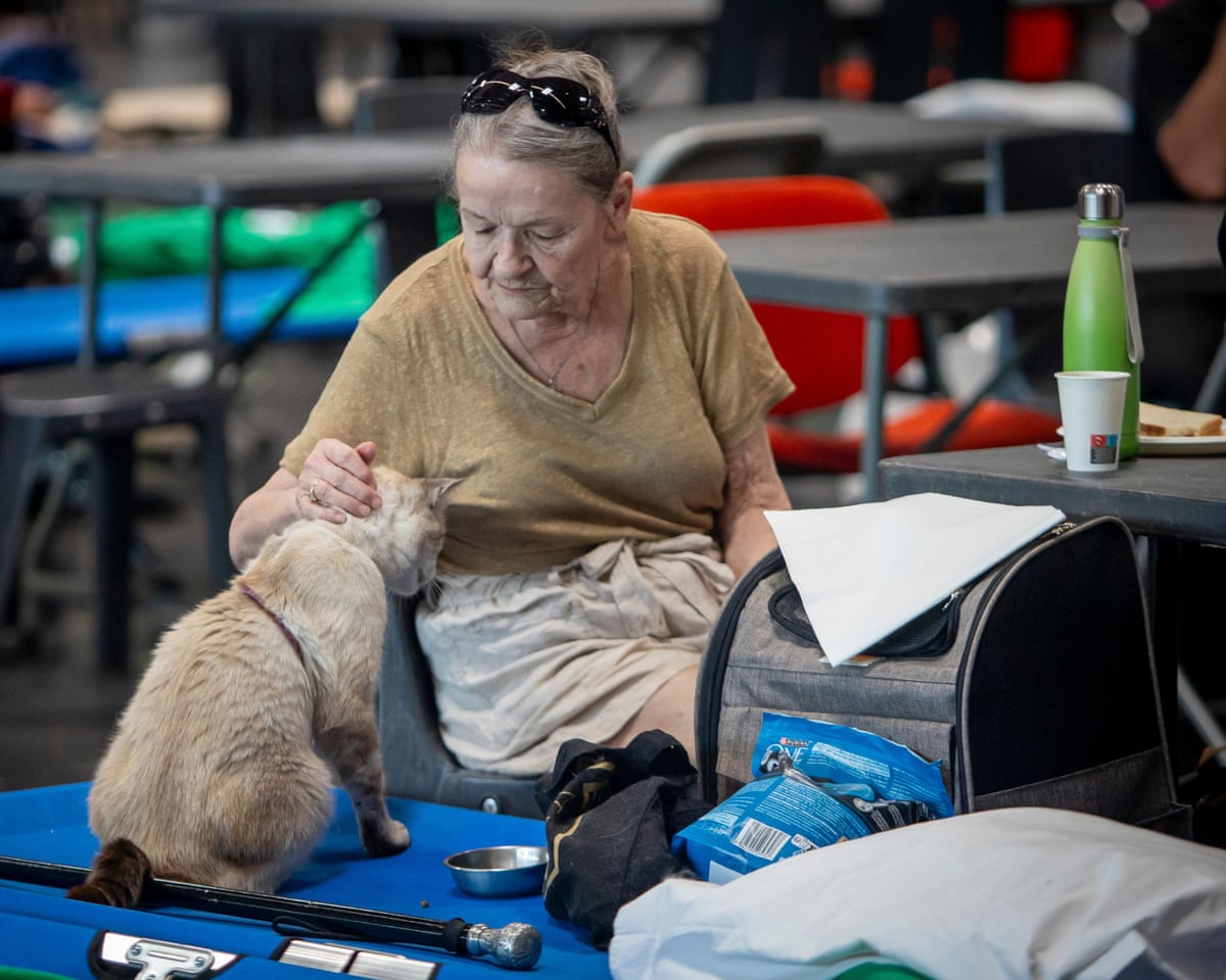Thousands of people evacuated from their homes rest at the Bordeaux Exhibition Centre, which has been converted into a temporary emergency shelter following a major wildfire affecting the Gironde department in southwestern France.