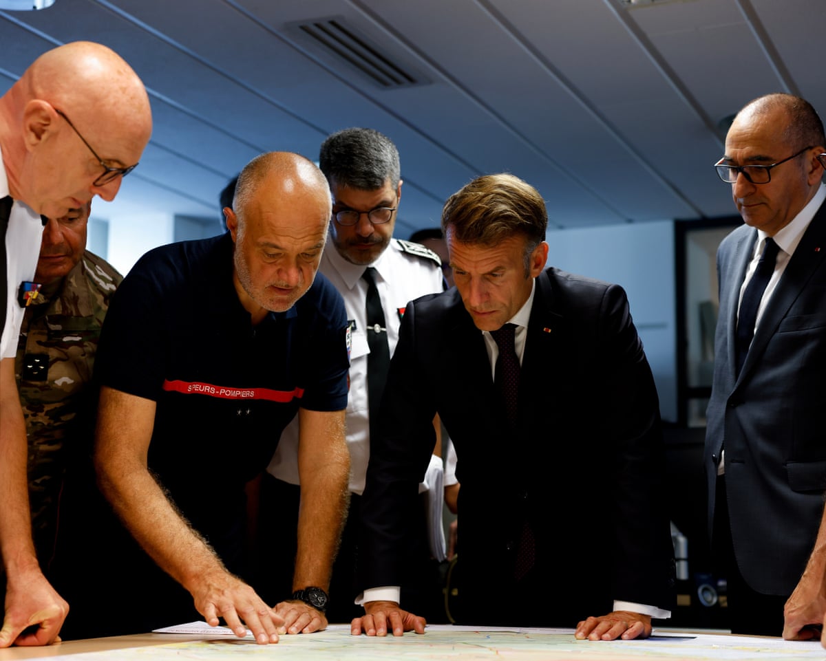 France's President Emmanuel Macron and France's interior minister Laurent Nuñez listen to SDIS 33 Fire and Rescue Service Departemental director Marc Vermeulen during a situation briefing in the crisis room at the Departmental Fire and Rescue Operational Center (CODIS) in Bordeaux.