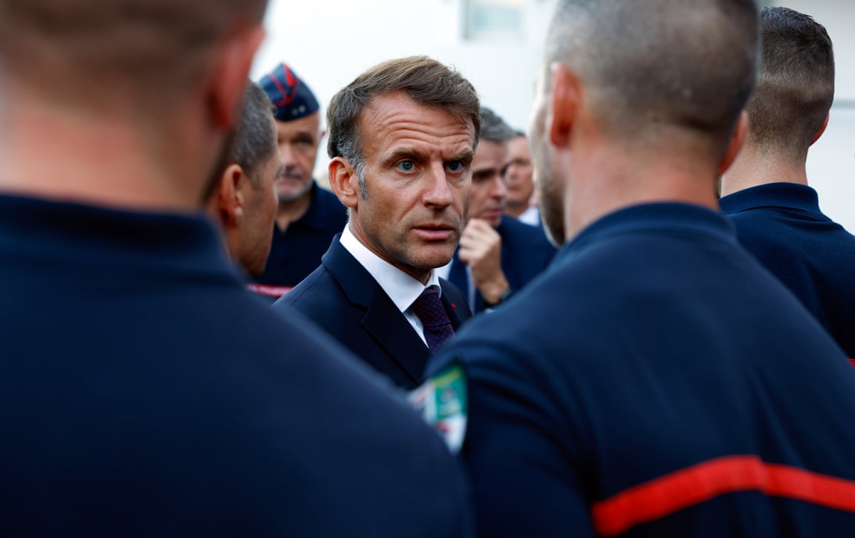 French president Emmanuel Macron speaks with firefighters