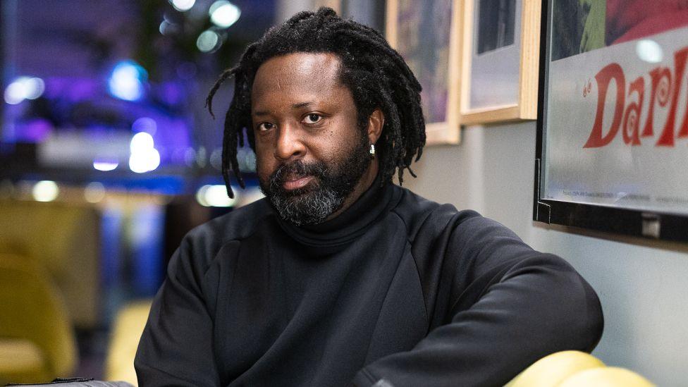 Marlon James during the BFI Presents Get Millie Black TV preview at BFI Southbank on February 18, 2025 in London, England. has a beard and is wearing a black sweater.