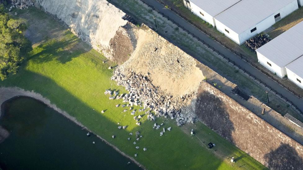 An aerial view shows a collapsed part of Kumamoto Castle's stone walls.