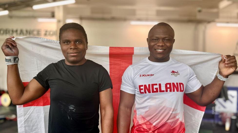 Cyrille Tchatchet II and Madias Ngake holding an England flag
