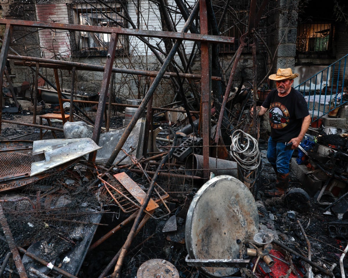 A man is pictured at his burnt-out home following a devastating wildfire in Pelayos de la Presa, 65 kilometers west of Madrid, Spain.
