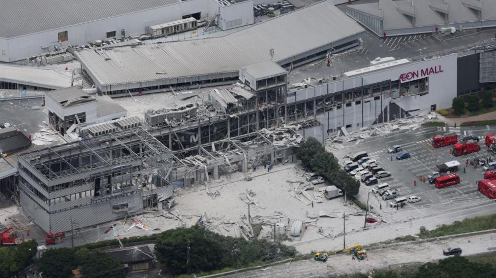 An aerial shot of Aeon Mall which has collapsed with debris surrounding the building