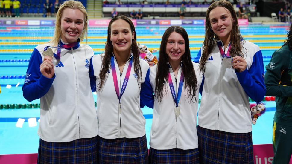 Commonwealth Games 2026 - Swimming - Tollcross International Swimming Centre, Glasgow, Scotland, Britain - July 29, 2026 Silver medallists Scotland's Katie Shanahan, Angharad Evans, Keanna Macinnes and Evelyn Davis celebrate on the podium after the women's 4 x 100m medley 