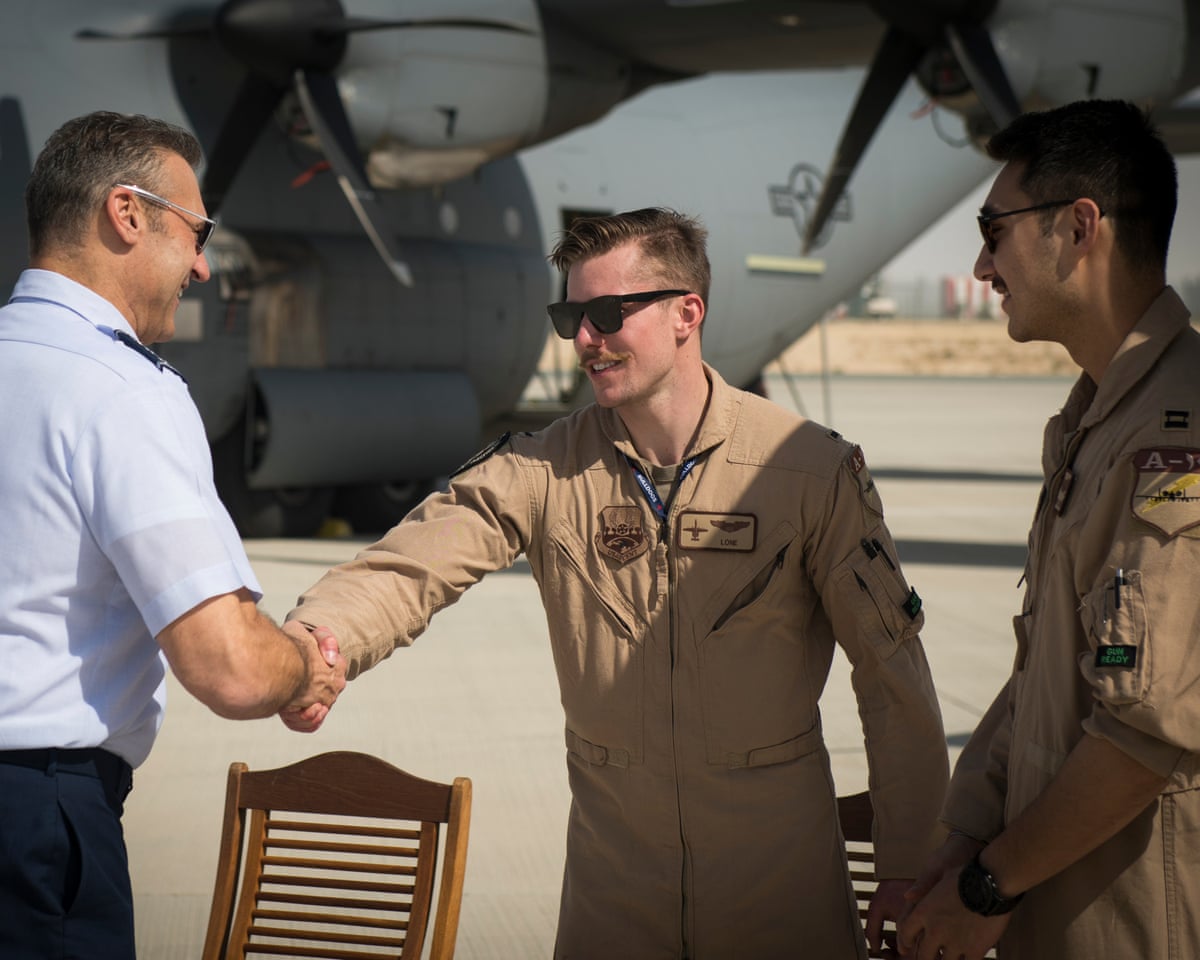 Capt Jacob Wulfson, centre, pictured at the Dubai Airshow with two people unrelated to the case