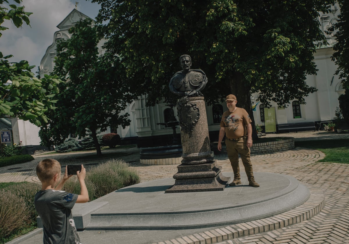 A bust of Ivan Mazepa in Kyiv’s Pechesk Lavra. Mazepa monastery with a tourist having his photo taken next to it