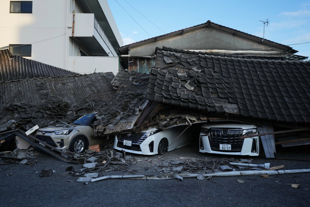 Vehicles are crushed under collapsed buildings