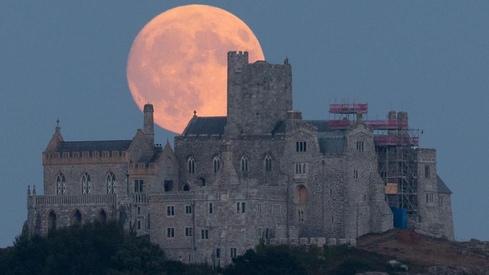 The Buck Moon rising behind St Michael's Mount in Cornwall.