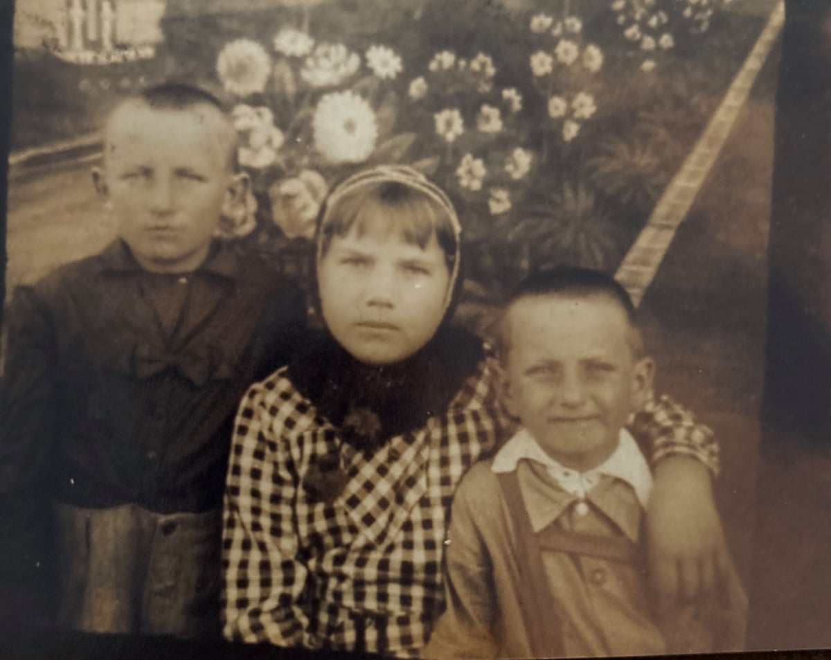 Sepia tint photo of Czeslaw Krupa, left, with his brother and cousin in Africa in 1944