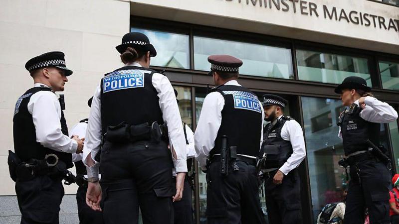 Police officers seen during a demonstration outside Westminster Magistrates' Court