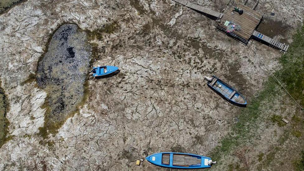 Boats laying on the dried Danube river bed in front of the Calafat-Vidin bridge, connecting Bulgaria and Romania