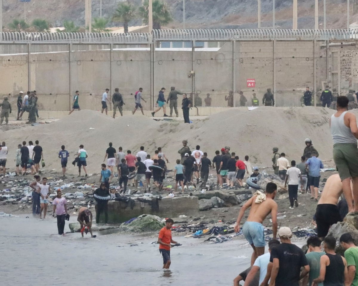 Groups of migrants return to Morocco through the Tarajal border crossing in Ceuta, Spain.