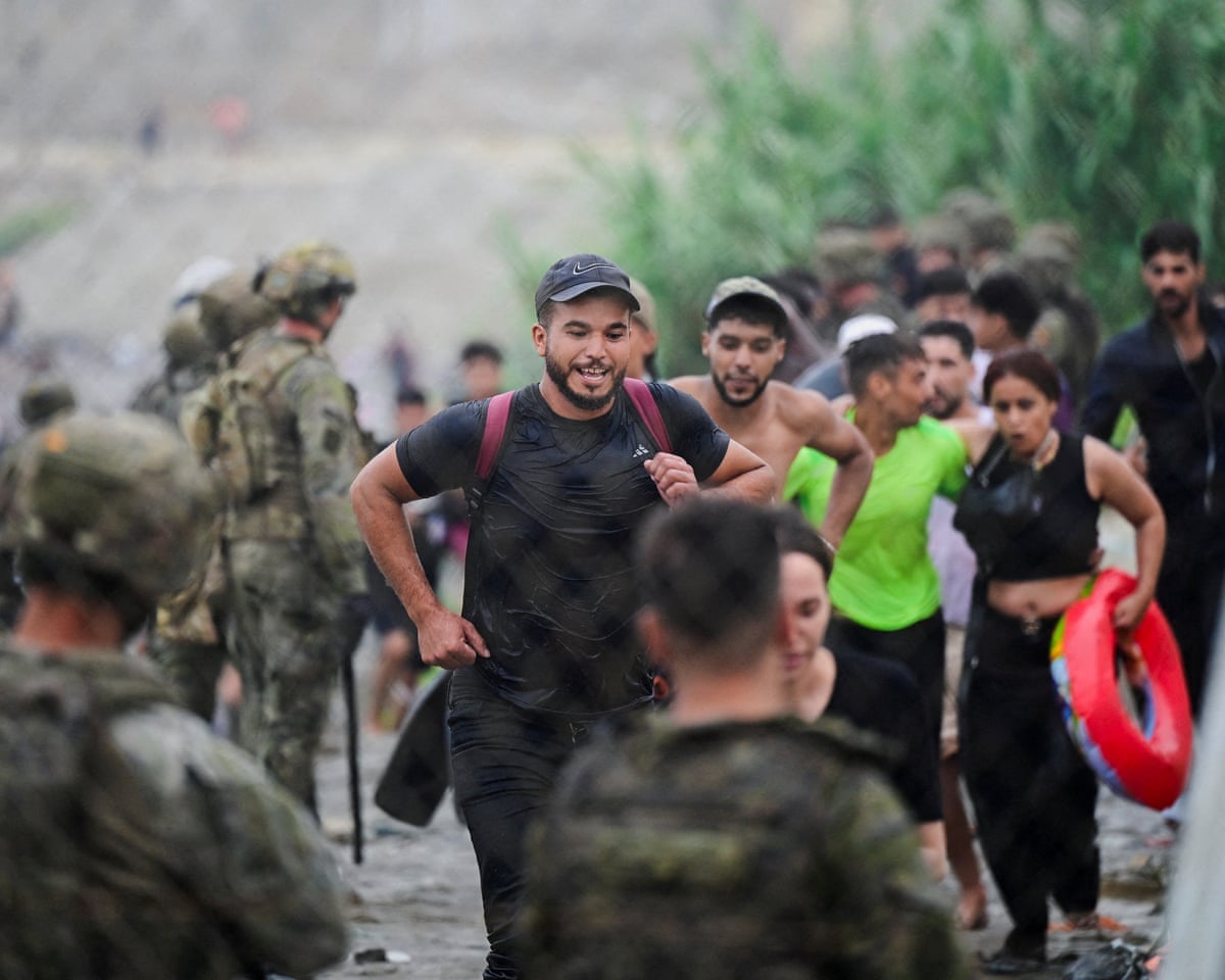 Migrants from Morocco arrive at the Spanish border, in Ceuta, Spain.