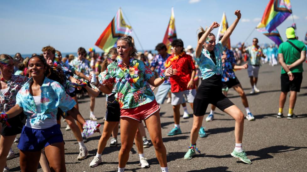 People take part in the Brighton & Hove Pride Community Parade during the annual Brighton Pride Festival in Brighton.