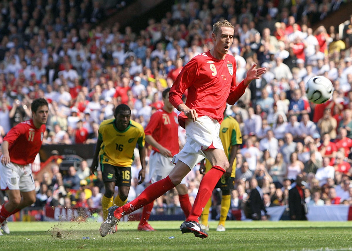 The England striker Peter Crouch reacts in horror after taking a penalty that is on its way over the bar in a pre-2006 World Cup friendly against Jamaica,