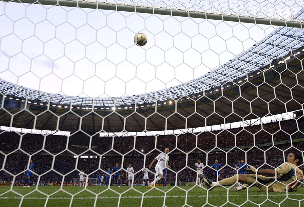 The France midfielder Zinedine Zidane, standing by the penalty spot, and the Italy goalkeeper Gianluigi Buffon, on the floor having dived to his right, watch as Zidane’s penalty goes in in the 2006 World Cup final.