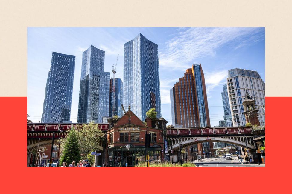 A view of the skyline in Manchester City Centre. An Edwardian building and a bridge are in the foreground with skyscrapers in the background.