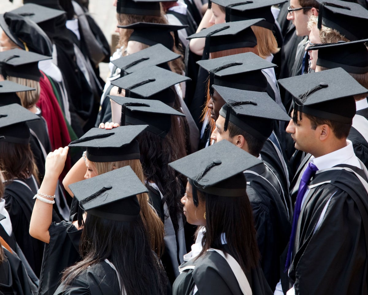 Graduates wait to be photographed after a degree ceremony at Birmingham university in the UK