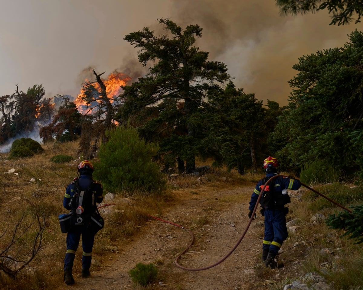 Firefighters operate on Mount Kithairon near Porto Germeno, northwest of Athens, Greece.