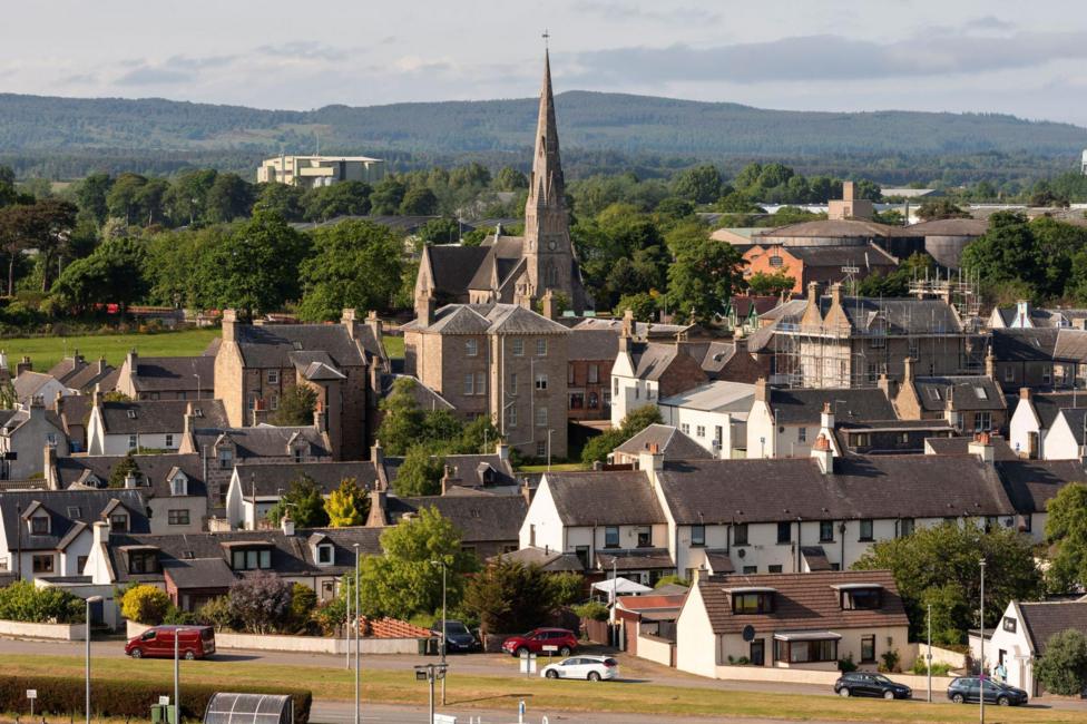 A view of Invergordon in the Highlands showing houses and church with a steeple.