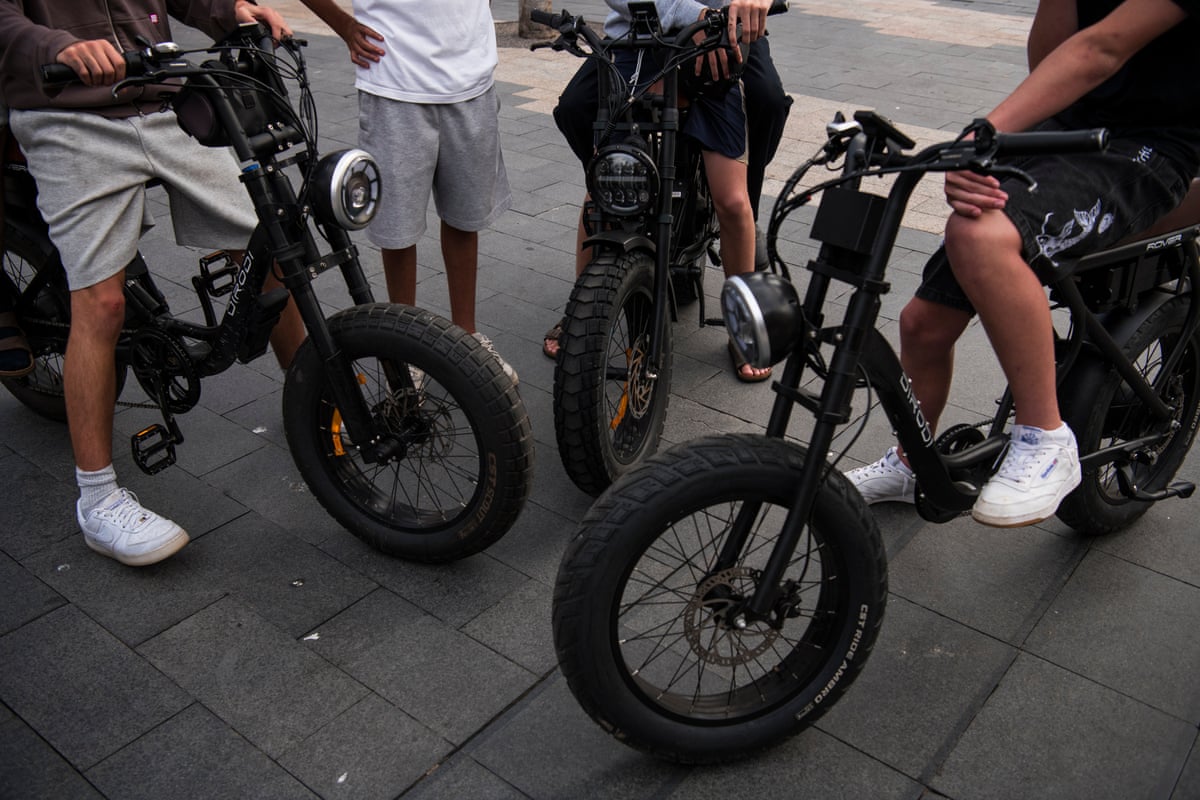 Schoolboys cruise on ebikes on Sydney’s northern beaches.