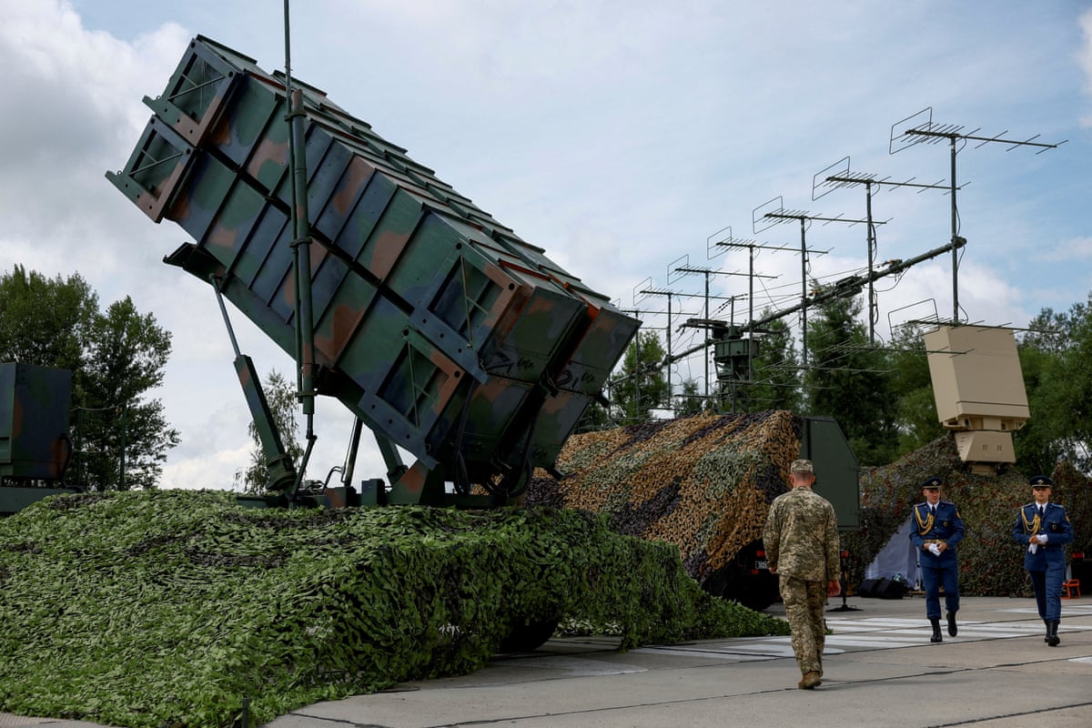 Ukrainian service members view a Patriot air defence system in 2024.