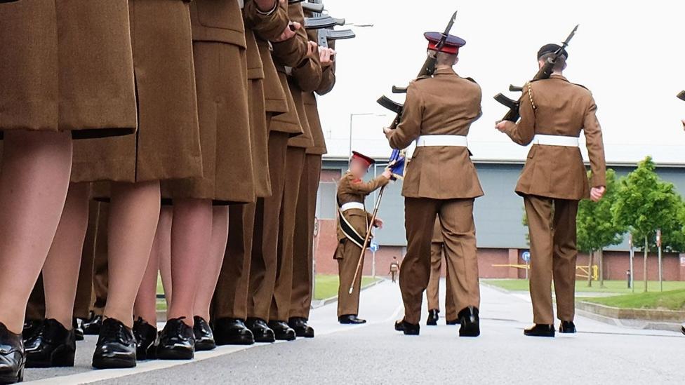 A stock image shows the feet of junior soldiers lining up with guns as they prepare to march ahead of their graduation parade at the Army Foundation College in 2015.