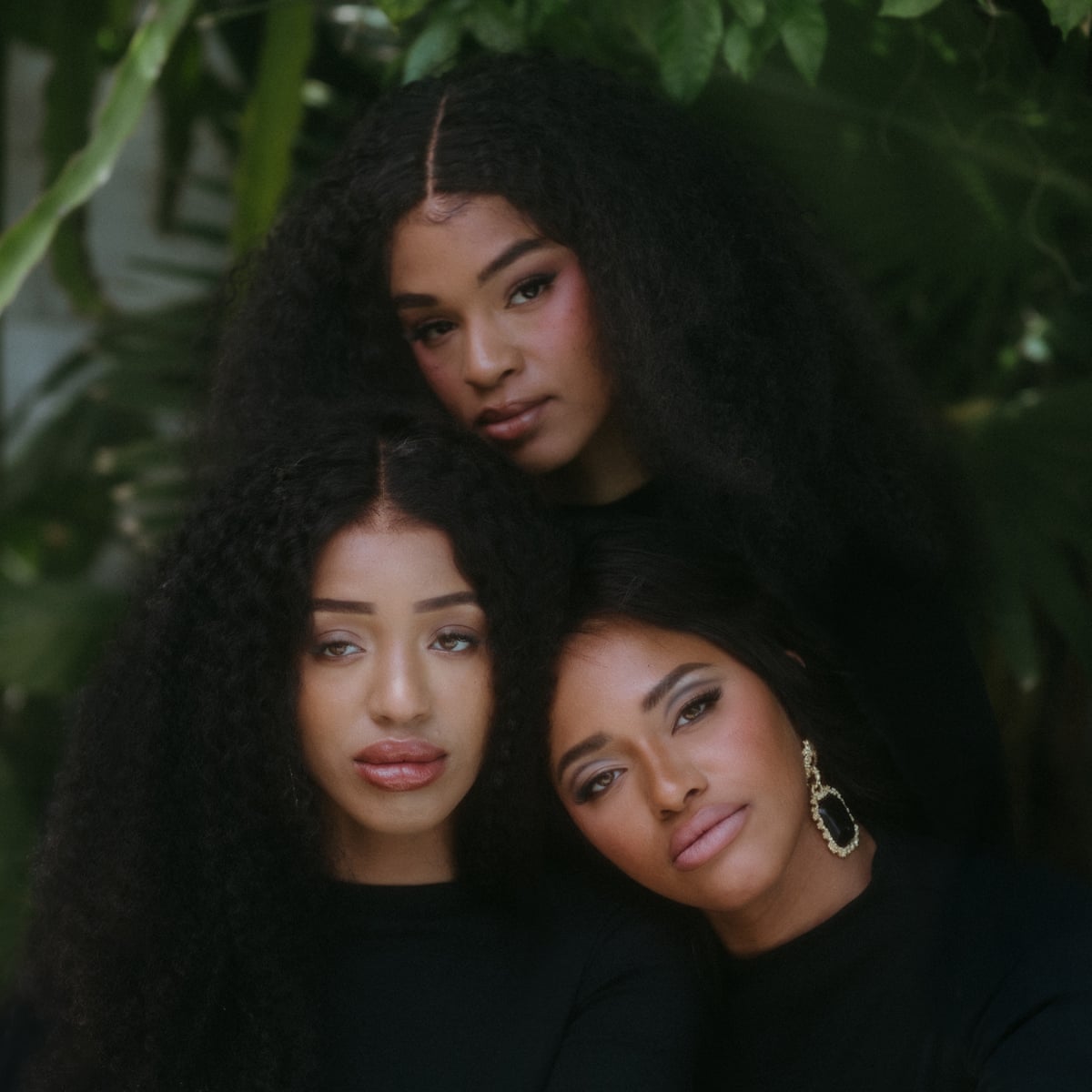 Close up portrait of the three sisters, heads together