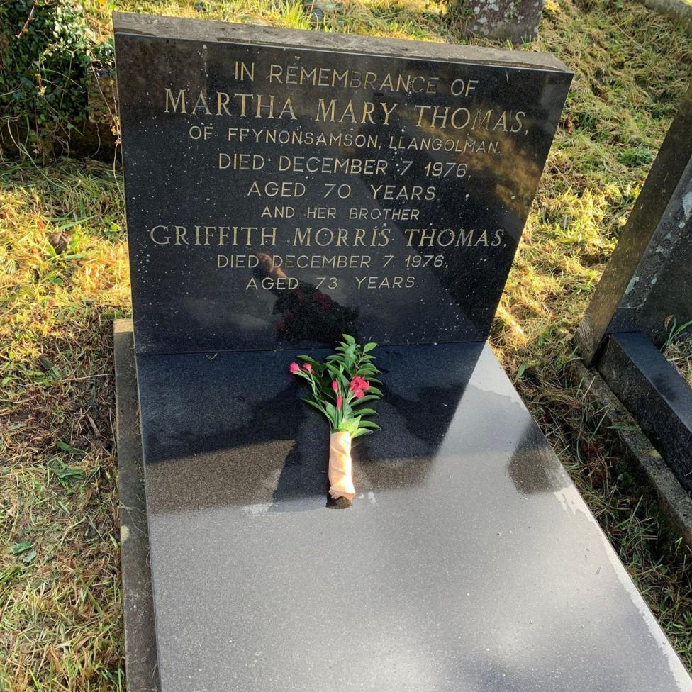 The siblings' grave, with a bunch of flowers placed on top.