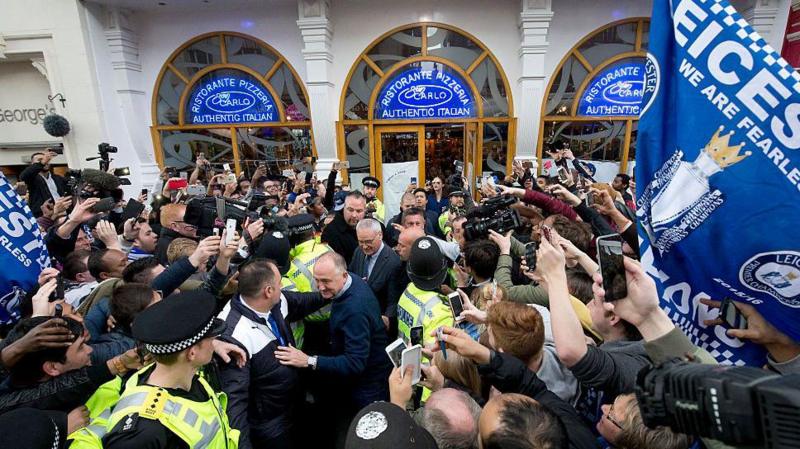 Claudio Ranieri is mobbed by fans on his way out of an Italian restaurant
