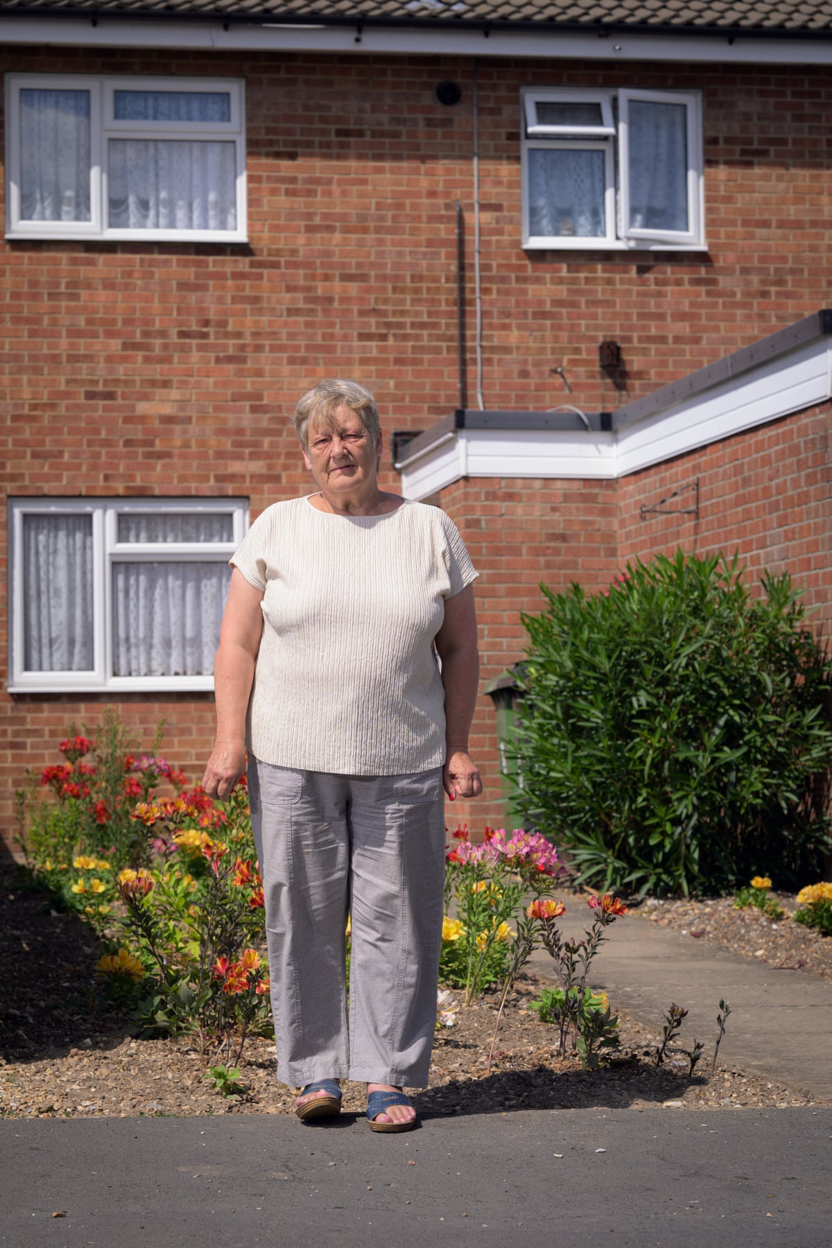 Jenny Hollis standing outside a terraced house