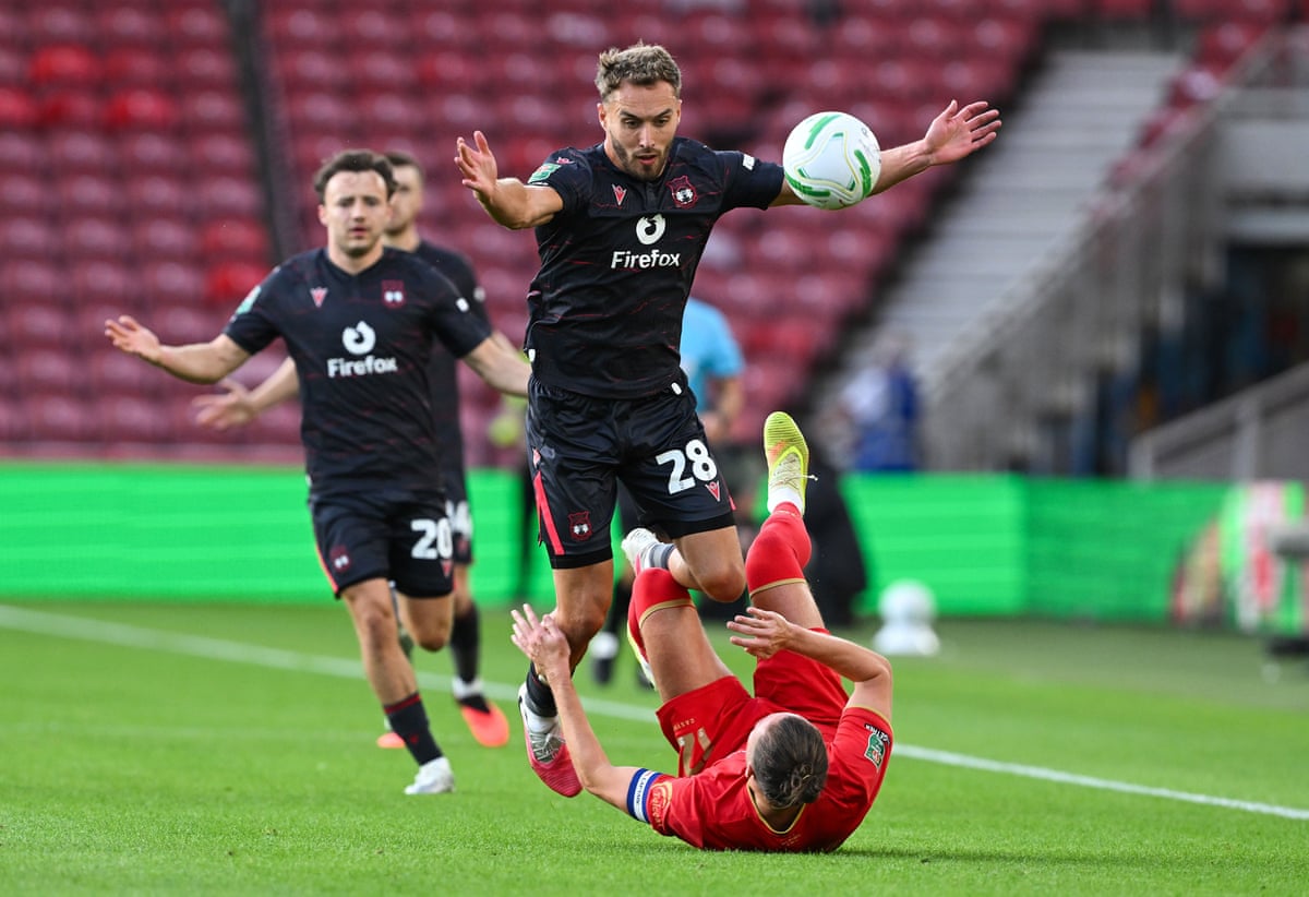 Sam Smith of Wrexham fouls Luke Ayling of Middlesbrough.