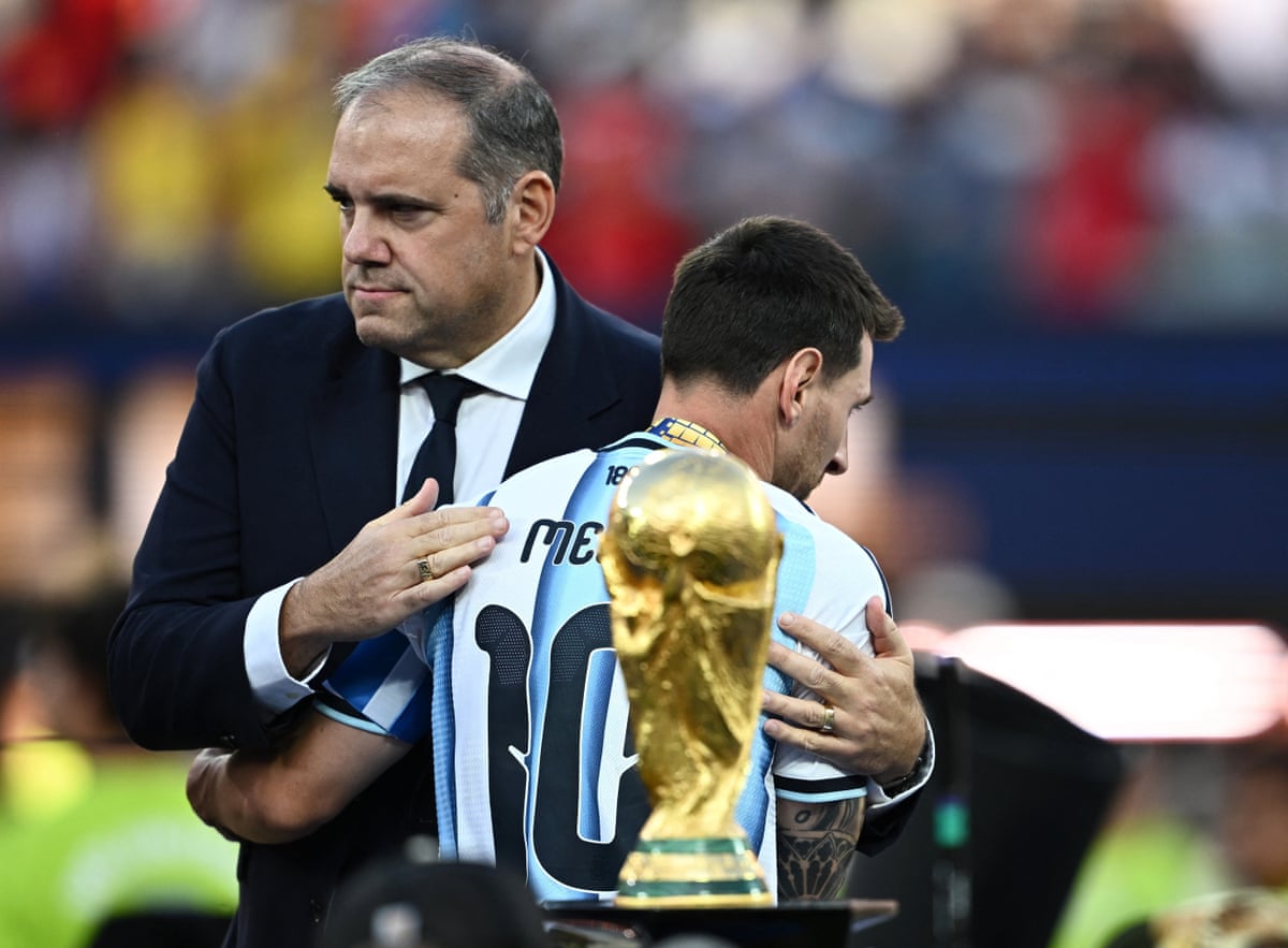 Victor Montagliani embraces Lionel Messi after the World Cup final in July.