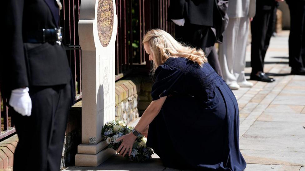 Andrew Harper's widow Lissie Harper lays a wreath at a memorial stone in Reading