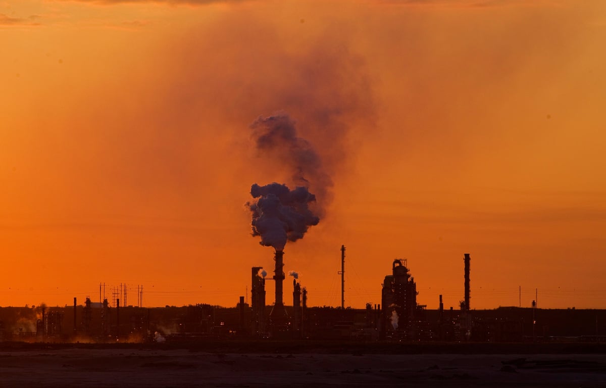 The Syncrude Canada Ltd. upgrader plant of the company's mine stands at dusk in the Athabasca Oil Sands near Fort McMurray, Alberta, Canada
