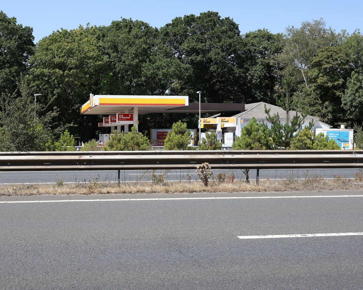 A closed petrol station on the far side of an empty dual carriageway