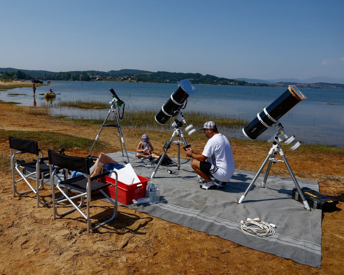 Frenchman Leyssalle Anthony, 39, prepares a telescope to view the total solar eclipse from the beach, in Arija, Spain.