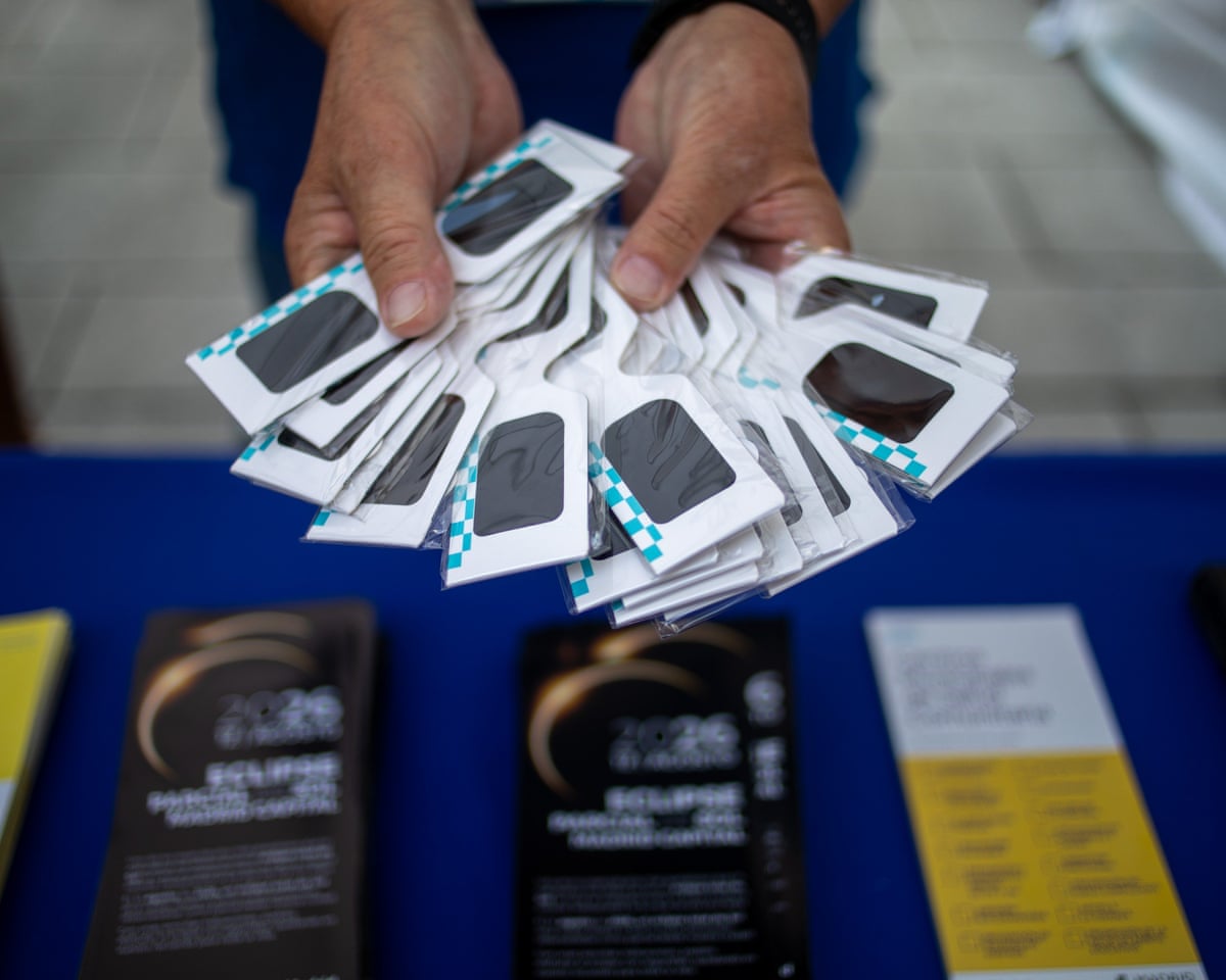 A man displays a range of eclipse glasses that will be distributed during a municipal information day so that Madrid residents can safely observe the eclipse.