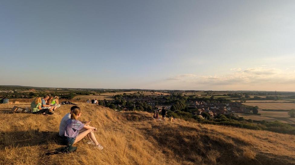 People watching the solar eclipse on a hill