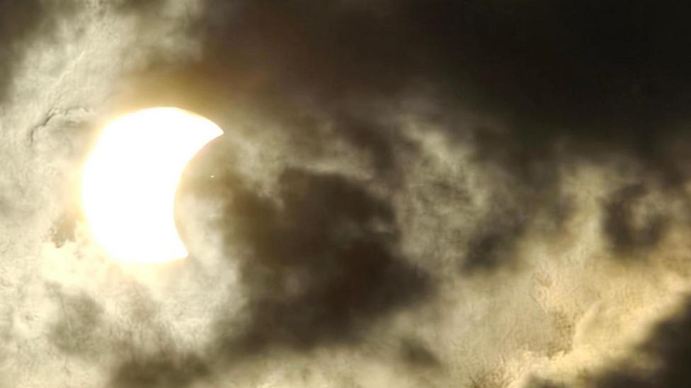 Cloudy sky obscures the partial eclipse, or possibly makes it safer to view