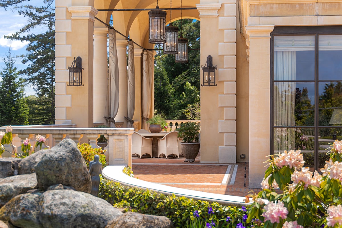 Columns and lamps outside of a lavish house