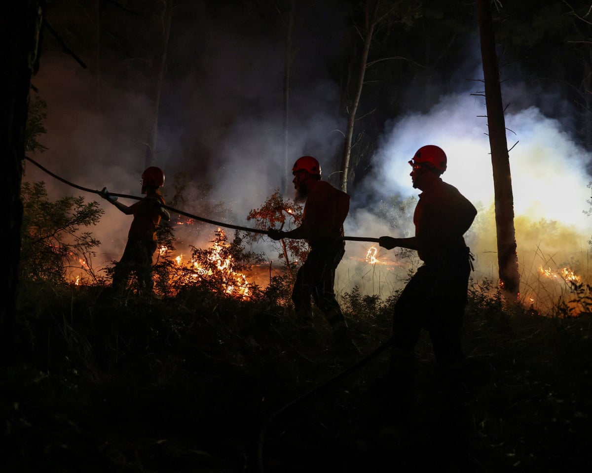 Firefighters work to extinguish a wildfire fanned by strong winds near the resort of Siviri on the Halkidiki peninsula, Greece.