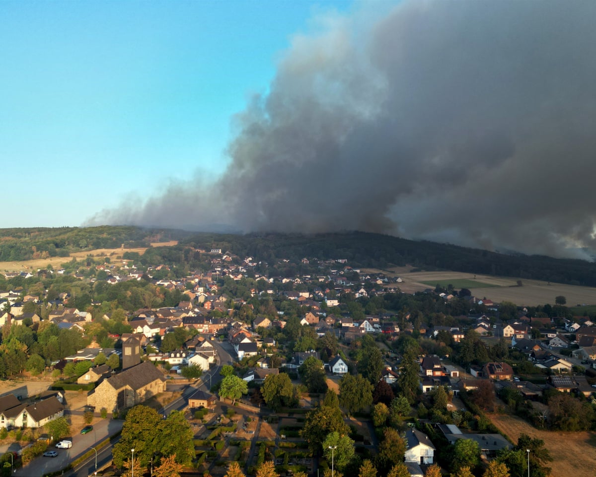 Thick smoke drifts over the Gey district from a forest fire in Hürtgenwald, Germany.