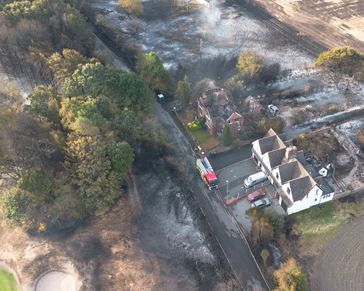 An aerial view shows burnt houses as the wildfire continues to spread to the golf course in Stourbridge, England.