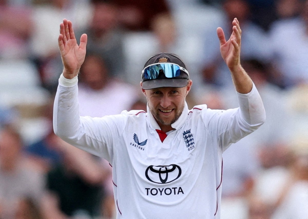 England men’s Test cricket captain Joe Root in uniform, raising both his hands above his head