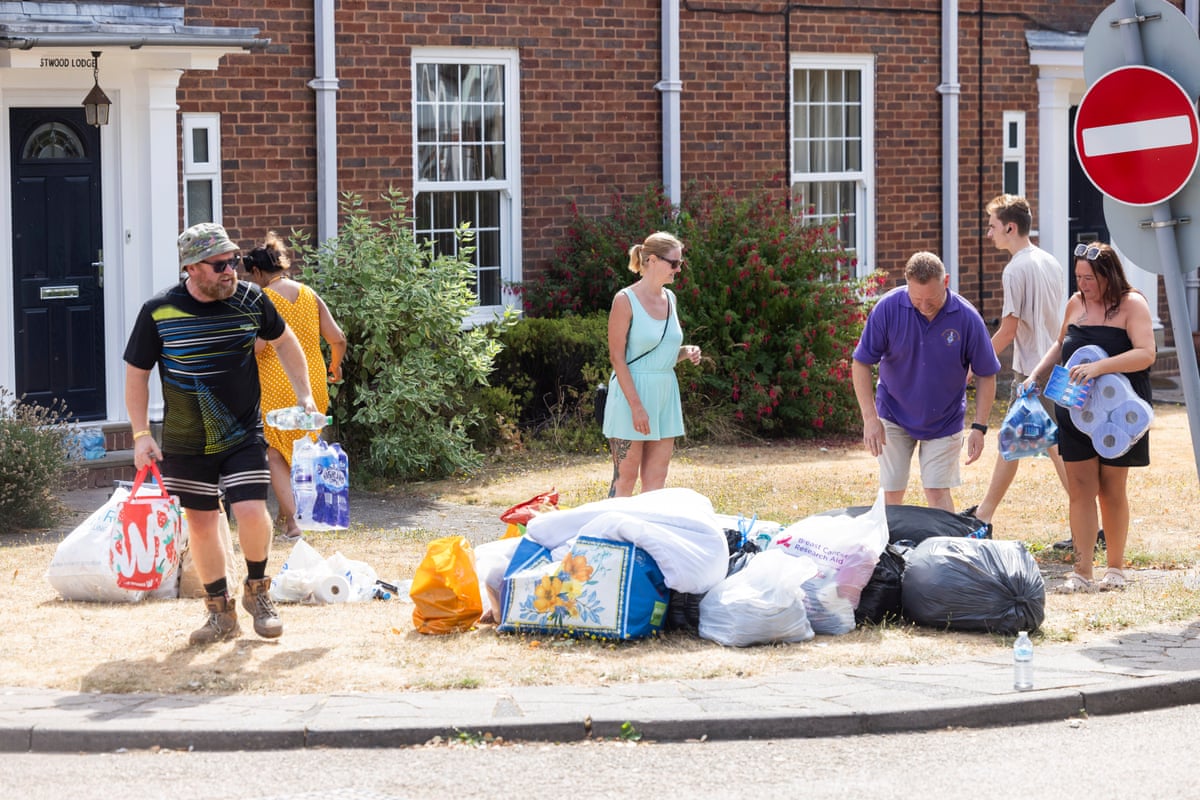People looking at and moving bags