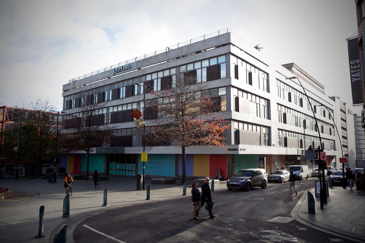 The now closed John Lewis department store in Sheffield. There are coloured hoardings over the windows on the ground floor.