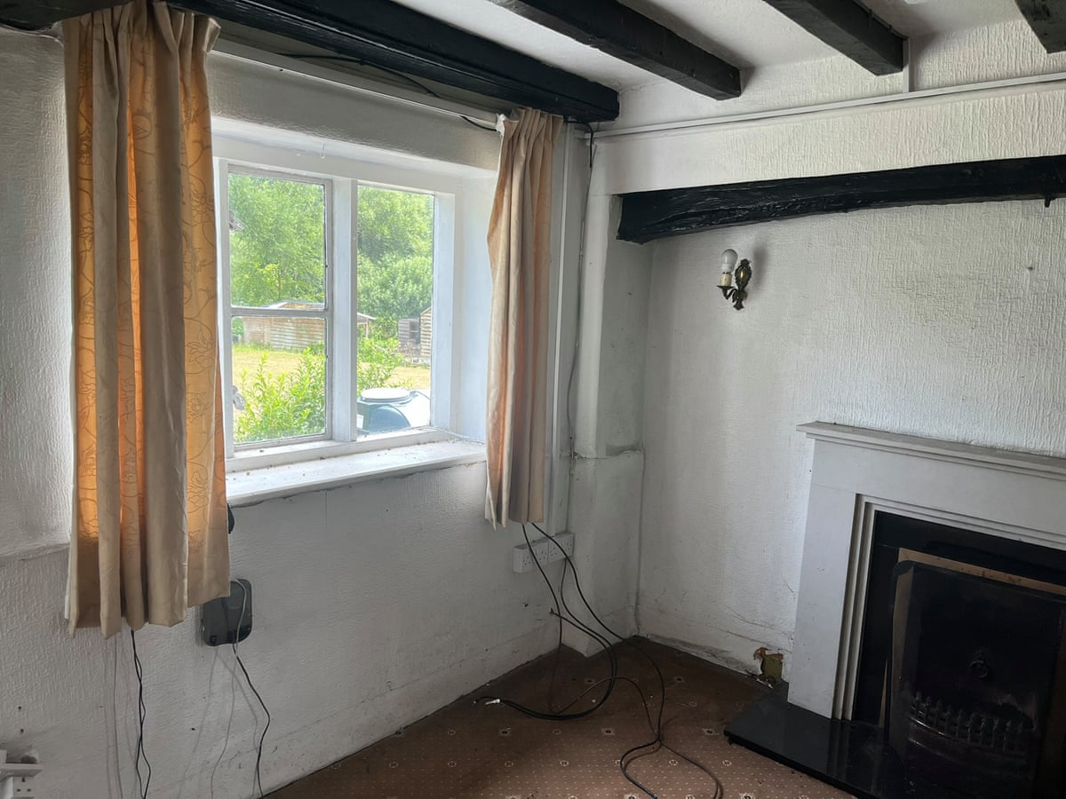 Run-down room with single-glazed windows and beams in the ceiling