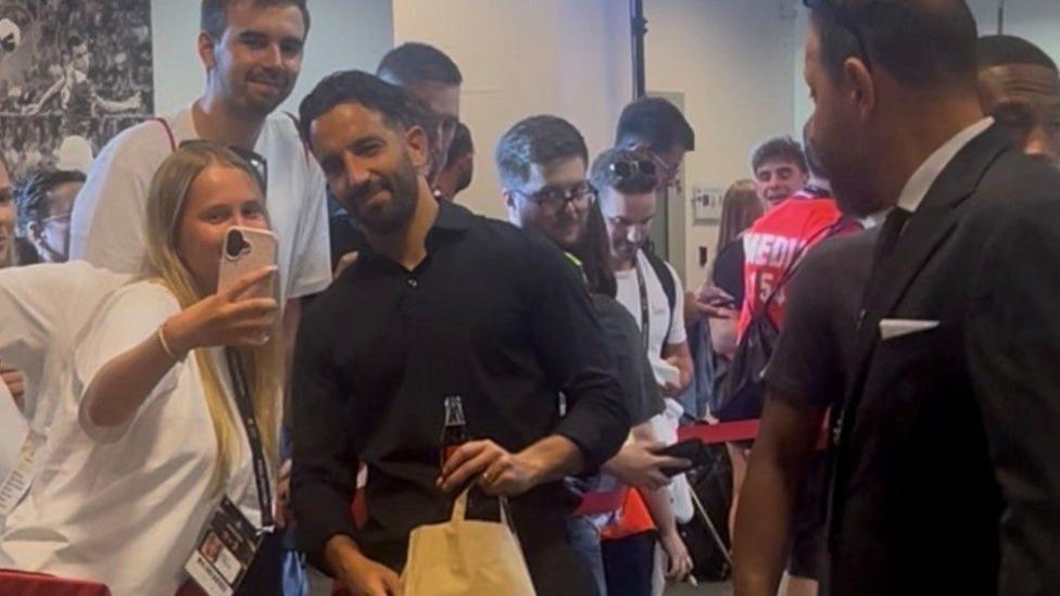 AC Milan boss Ruben Amorim poses for a selfie in the mixed zone
